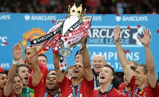 Rio Ferdinand lifts the Premier League trophy at Old Trafford on May 12, 2013
